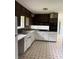 Kitchen featuring white cabinetry, modern appliances and tile flooring at 6192 Meadowbrook Dr, Norcross, GA 30093