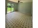 Bright living room with black and white tile flooring and sliding glass doors to the backyard at 6192 Meadowbrook Dr, Norcross, GA 30093