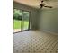 Living room featuring sliding glass doors, ceiling fan and vinyl tile flooring at 6192 Meadowbrook Dr, Norcross, GA 30093