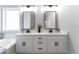 Bright bathroom features a double vanity with white cabinets, dark hardware, and framed mirrors at 21 Spring Folly Nw, Cartersville, GA 30121