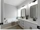 Bright bathroom features a tub, double vanity with white cabinets and dark hardware at 21 Spring Folly Nw, Cartersville, GA 30121
