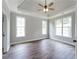 Bedroom features tray ceiling, neutral walls, hardwood floors, and natural light at 21 Spring Folly Nw, Cartersville, GA 30121