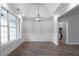 Bright dining area with large windows, modern chandelier, and elegant wainscoting at 21 Spring Folly Nw, Cartersville, GA 30121