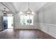 Dining room featuring hardwood floors, large window, modern light fixture, and entry to other rooms at 21 Spring Folly Nw, Cartersville, GA 30121