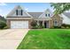 Charming brick home with a well-manicured lawn and inviting curb appeal on a sunny day at 21 Spring Folly Nw, Cartersville, GA 30121