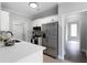 Well lit kitchen with white cabinets, stainless steel appliances and stone backsplash at 21 Spring Folly Nw, Cartersville, GA 30121