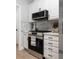 Close-up of stainless steel gas range and overhead microwave in neutral kitchen at 21 Spring Folly Nw, Cartersville, GA 30121