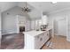 Open concept kitchen with an island, white cabinetry, stone backsplash, and stainless steel appliances at 21 Spring Folly Nw, Cartersville, GA 30121
