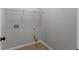 Neutral laundry room with tile flooring and upper wire shelving at 21 Spring Folly Nw, Cartersville, GA 30121