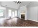 Open living area featuring a fireplace, fan, hardwood flooring, and doorway to the kitchen at 21 Spring Folly Nw, Cartersville, GA 30121