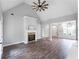 Bright living room featuring hardwood floors, fireplace, vaulted ceiling, and open floor plan at 21 Spring Folly Nw, Cartersville, GA 30121