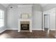 Spacious living room featuring a fireplace, hardwood floors, a vaulted ceiling, and neutral decor at 21 Spring Folly Nw, Cartersville, GA 30121