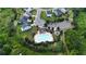 Aerial view of the community pool, surrounding homes, a playground and manicured landscaping at 5090 Bellehurst Ln, Cumming, GA 30040