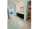 Bathroom with a double sink vanity, large mirror and patterned floor mats at 5090 Bellehurst Ln, Cumming, GA 30040