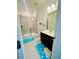 Tidy bathroom featuring tiled floors, glass shower, and a dark vanity at 5090 Bellehurst Ln, Cumming, GA 30040