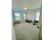 Bright bedroom with neutral walls and carpet, offers two large windows for plenty of natural light at 5090 Bellehurst Ln, Cumming, GA 30040