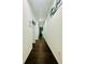 Bright hallway with hardwood floors, white walls and recessed lighting at 5090 Bellehurst Ln, Cumming, GA 30040