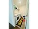 Functional laundry room featuring a washer, dryer and storage shelving at 5090 Bellehurst Ln, Cumming, GA 30040