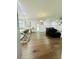 Open-concept living space with a kitchen island, bar seating and hardwood floors throughout at 5090 Bellehurst Ln, Cumming, GA 30040