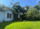 Light blue home with a covered front porch damaged by fallen trees at 702 Emily Pl # 0, Atlanta, GA 30318