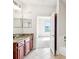 Bright bathroom featuring double mirrors, tile flooring, wooden cabinets and a view to bedroom at 799 Hammond Dr # 325, Atlanta, GA 30328