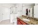 Bright bathroom featuring a granite countertop, framed mirror, tile flooring, and walk-in shower at 799 Hammond Dr # 325, Atlanta, GA 30328
