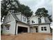 Charming two-story home with gray siding, an attached garage, and professionally landscaped yard at 99 Mountain Brook Dr, Cumming, GA 30041