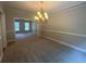 Open dining room featuring a chandelier and views to another room at 100 Hamilton Glen Ct, Fayetteville, GA 30215