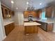 Well-lit kitchen featuring tile flooring, cabinets, and stainless steel appliances at 100 Hamilton Glen Ct, Fayetteville, GA 30215