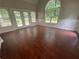 Bright living room featuring hardwood floors, and large windows providing natural light at 100 Hamilton Glen Ct, Fayetteville, GA 30215