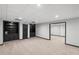 Basement area with dark built-in shelving units and carpet flooring at 1045 River Pt, Suwanee, GA 30024