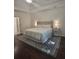 Neutral bedroom features a tray ceiling, a ceiling fan, and natural light at 1045 River Pt, Suwanee, GA 30024