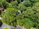 Aerial view of the home nicely situated within a canopy of trees at 2240 Six Branches Dr, Roswell, GA 30076