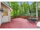 View of back deck with a table and four chairs overlooking the wooded backyard at 2240 Six Branches Dr, Roswell, GA 30076