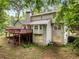 Back exterior view of the home, with a large deck and walkout basement at 2240 Six Branches Dr, Roswell, GA 30076