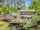 Back exterior view of the home, showcasing the deck and wooded backyard at 2240 Six Branches Dr, Roswell, GA 30076