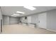 Bright finished basement with neutral carpet, built-in benches, and a convenient exterior door at 2240 Six Branches Dr, Roswell, GA 30076
