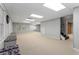 Spacious finished basement with recessed lighting, plush carpet, and cozy seating at 2240 Six Branches Dr, Roswell, GA 30076