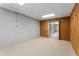 Unfinished basement area with wood paneling and brick, leading to another finished room at 2240 Six Branches Dr, Roswell, GA 30076
