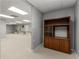 Finished basement area with plush carpeting and a wooden bookcase for ample storage at 2240 Six Branches Dr, Roswell, GA 30076