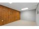 Unfinished basement area showcasing wood paneling and white brick accent wall at 2240 Six Branches Dr, Roswell, GA 30076