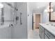 Bathroom with quartz countertop, glass-enclosed shower with double shower heads and marble floors at 2240 Six Branches Dr, Roswell, GA 30076