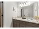 Bathroom featuring double sinks, a large mirror, decorative accents, and good lighting at 2240 Six Branches Dr, Roswell, GA 30076
