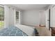 Bedroom with hardwood floors, windows, and a queen size bed with soft, white bedding at 2240 Six Branches Dr, Roswell, GA 30076