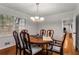 Dining room with hardwood floors, chandelier, and a wooden table with seating for six at 2240 Six Branches Dr, Roswell, GA 30076