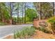 Elegant entrance to Martin's Landing community, beautifully landscaped with mature trees at 2240 Six Branches Dr, Roswell, GA 30076