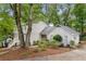 Inviting home exterior featuring mature trees, detailed landscaping, and a welcoming entrance at 2240 Six Branches Dr, Roswell, GA 30076