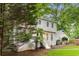 View of the home's exterior showcasing the two-story design and lush landscaping, enhancing its charm at 2240 Six Branches Dr, Roswell, GA 30076