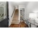 The home's foyer features a staircase and hardwood floors, creating a warm and inviting entrance at 2240 Six Branches Dr, Roswell, GA 30076