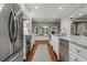 Spacious kitchen with white cabinets, stainless steel appliances, granite countertops, and window seating at 2240 Six Branches Dr, Roswell, GA 30076